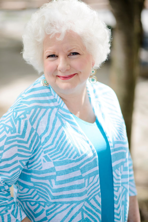 Colleen Bourassa smiling warmly in a turquoise top