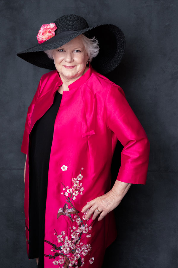 Colleen Bourassa in a stylish black hat and pink coat